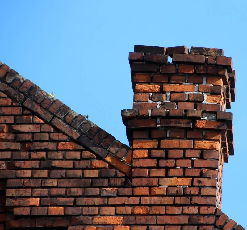 Signs Your Des Plaines Home Needs a Chimney Inspection Damaged chimney on an Des Plaines home showing cracks and missing mortar
